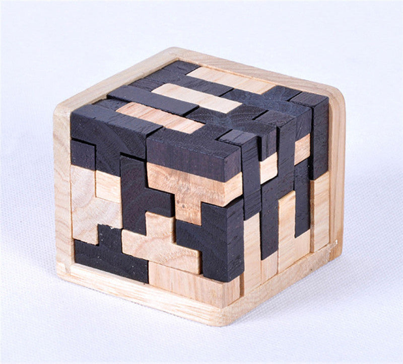 Wooden and black interlocking puzzle cube on a white background