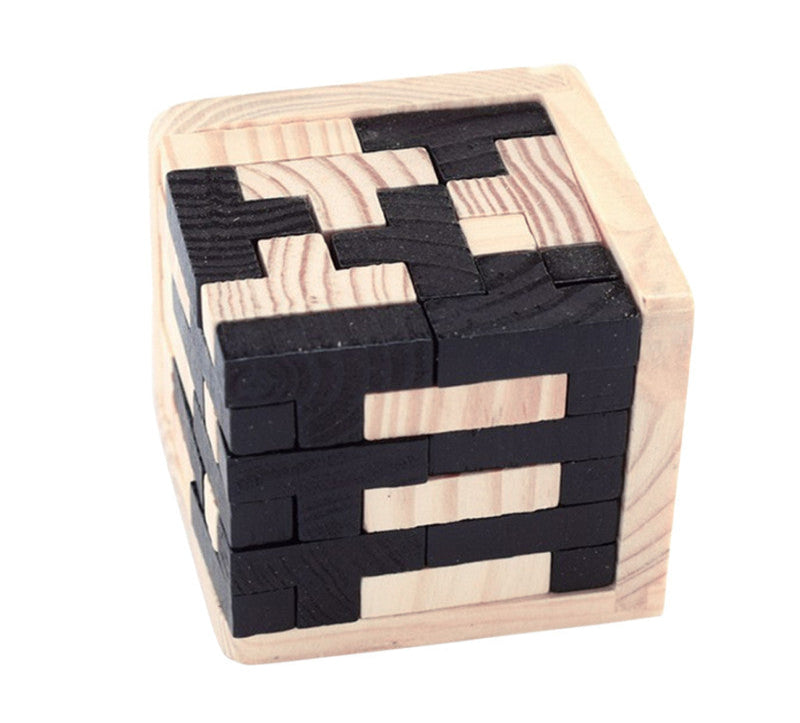 A 3D wooden puzzle made of interlocking blocks, some in black and others in a lighter wood color, arranged in a cube shape with a few blocks detached from the main structure.