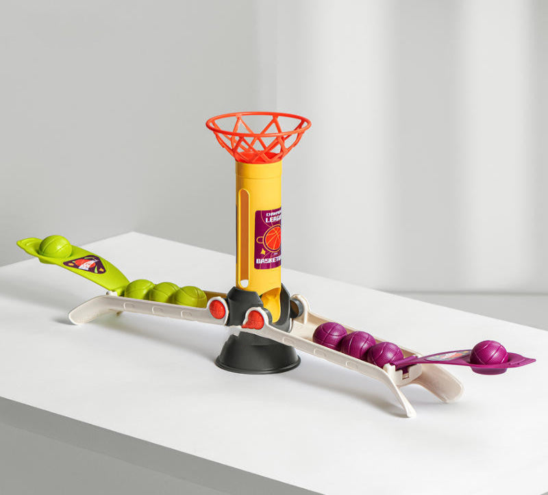Toy basketball hoop with colorful balls on a white surface