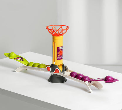 Toy basketball hoop with colorful balls on a white surface
