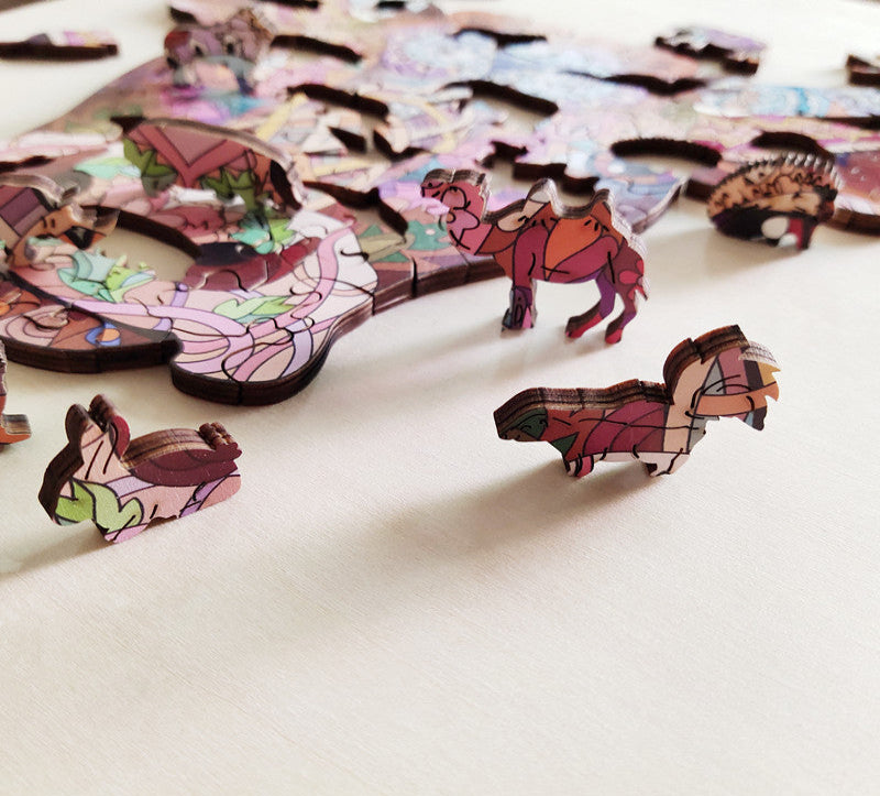 Colorful animal-shaped puzzle pieces on a white surface