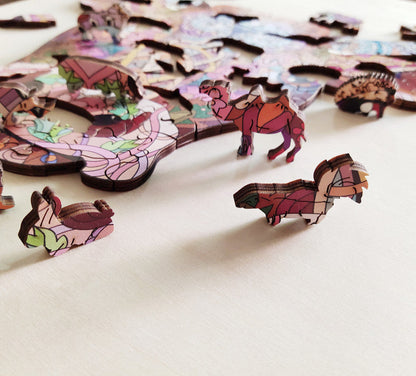Colorful animal-shaped puzzle pieces on a white surface