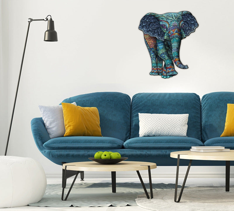 Decorative elephant wall art above a blue sofa with colorful cushions in a living room setting.