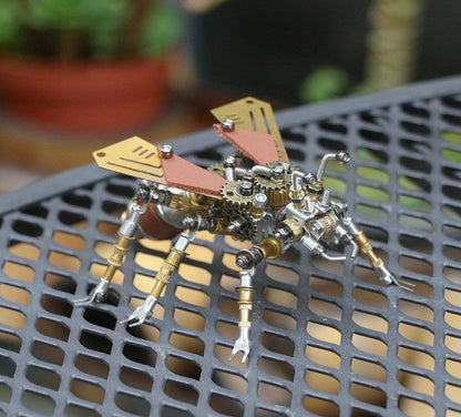 Metallic insect sculpture on a mesh table