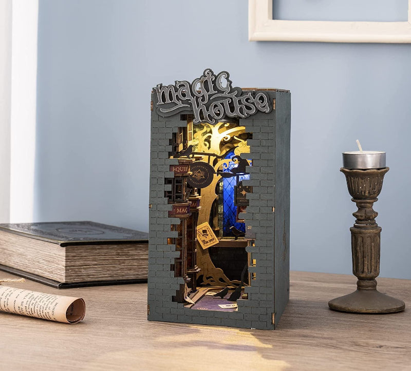 Decorative book-shaped box with mechanical design on a wooden surface