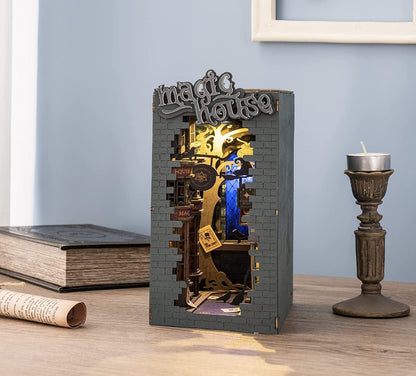 Decorative book-shaped box with mechanical design on a wooden surface