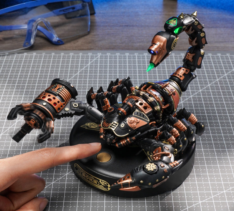 Detailed mechanical spider figure on a grid surface with a hand pointing at it
