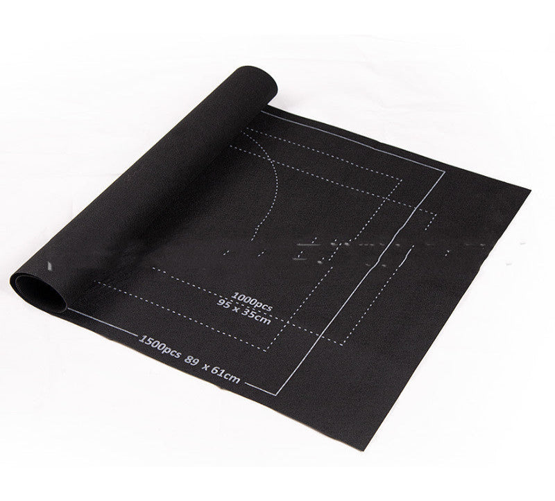 Black cutting mat with measurements on a white background