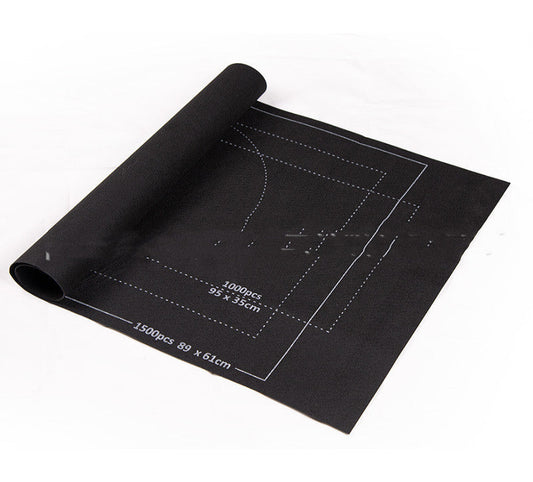 Black cutting mat with measurements on a white background