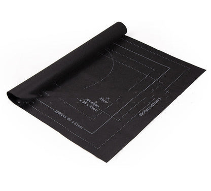 Black cutting mat with measurement markings on a white background