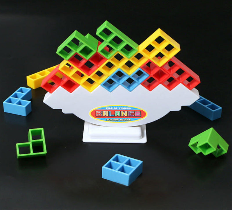 Colorful balance toy with geometric blocks on a black background