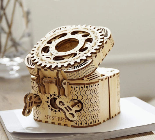 Wooden mechanical model with gears on a white surface