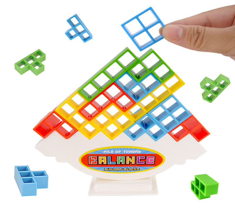 Colorful building block toy with a hand placing a blue block on top, on a white background.