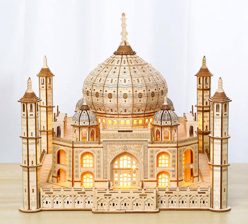 Wooden model of the Taj Mahal with illuminated interior on a light background